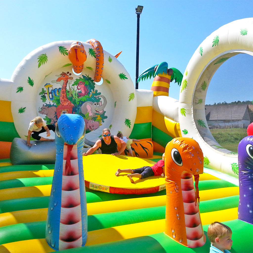 Eine Mutter spielt mit ihrem Sohn in einer Hüpfburg auf einer Drehbühne.