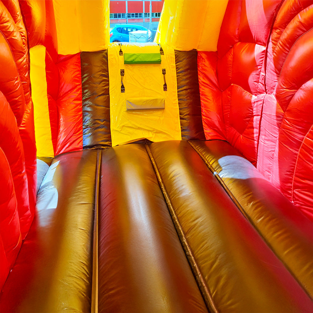 Eine braune Hüpffläche, rote Wände und einem kleinen Aufstieg in das Freie.