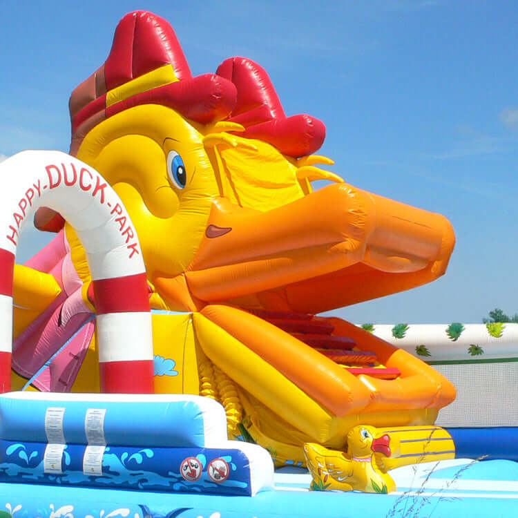 Gesicht Ente Aufblasbare Hüpfburg Ente Snappy Super mit Riesenrutsche, Entenkopf-Design, Palmen und Wasserpark-Elementen – bunter Spielspaß für Kinder