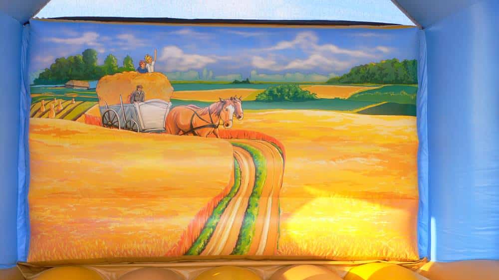 Eine Kutsche mit Pferden auf der Wand einer Hüpfburg
