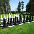 XXL chess with large pieces on an outdoor lawn