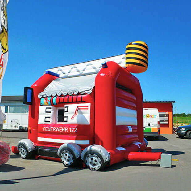 Fire department Huepfburg with window, mirror, ladder and tires on a concrete square with a fan at the back.