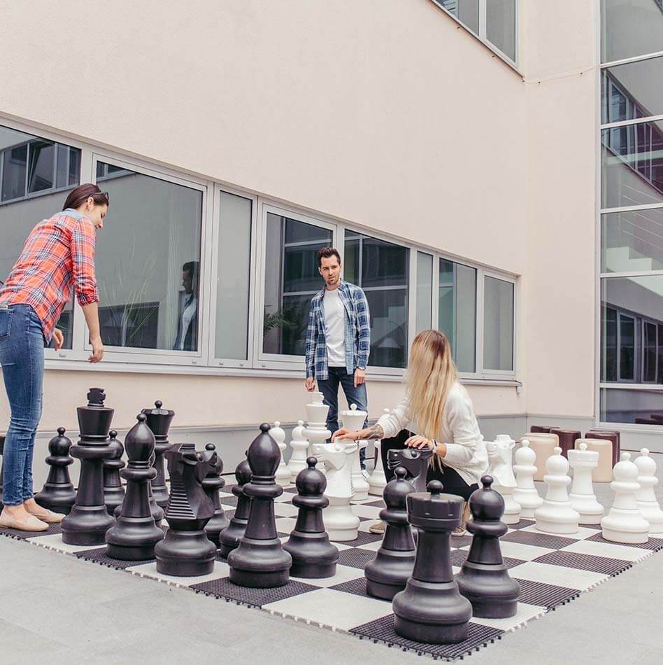 XXL chess with large pieces and players outside